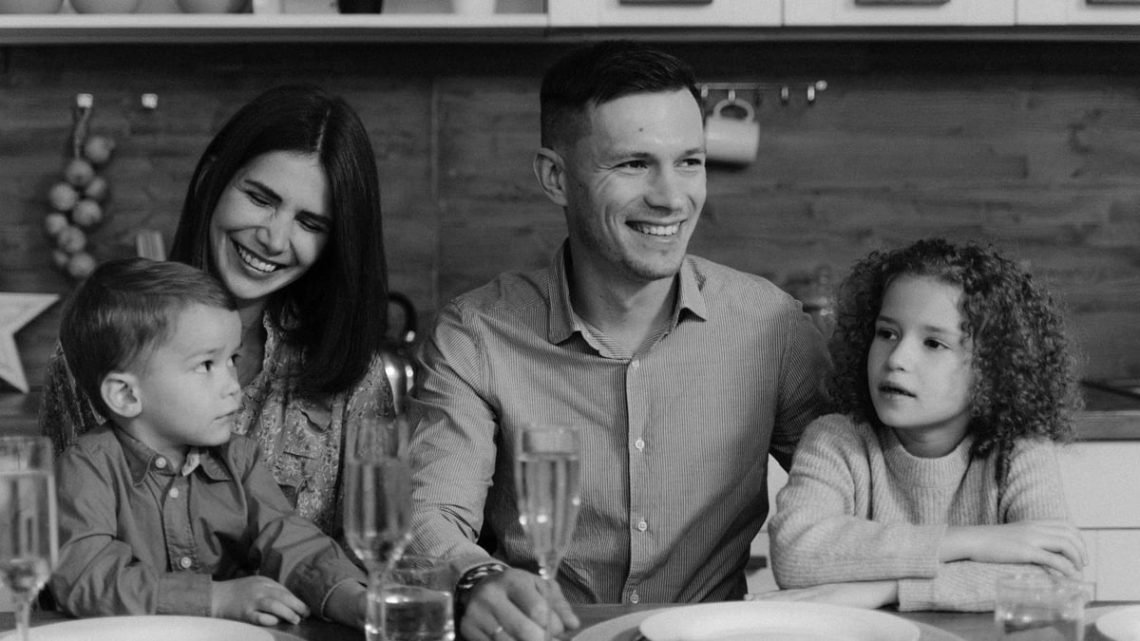 Smiling family enjoying quality time together at dining table in cozy kitchen.